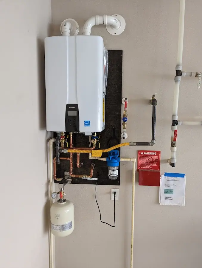 Professional plumber installing copper piping in a The Homesteads home